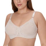 A woman is wearing a lace bra with adjustable straps and no underwire, featuring a small bow detail at the center.