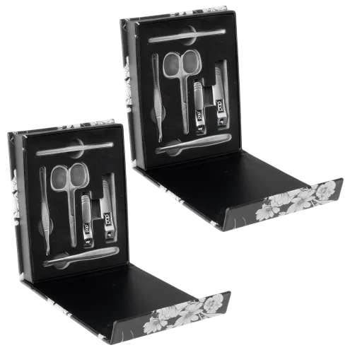 Two manicure sets in floral black boxes, each containing scissors, nail clippers, a nail file, tweezers, a cuticle pusher, and an ear pick.
