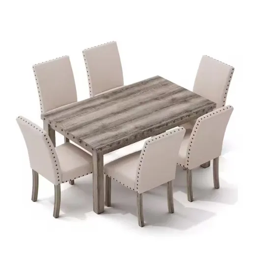 A dining set featuring a rectangular wooden table with a weathered finish and six beige upholstered chairs, each adorned with nailhead trim.