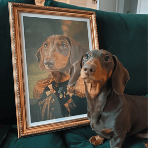 A dachshund sits beside a framed portrait depicting it as a noble figure in military attire.