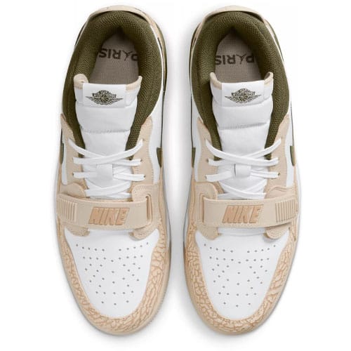 A pair of beige and white Nike sneakers viewed from above.