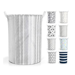 A laundry hamper with a chevron pattern and a set of decorative waste paper baskets in various designs.