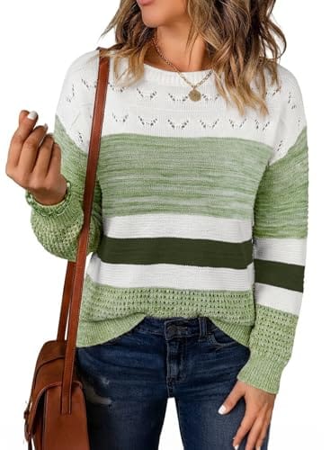 Woman wearing a green and white striped sweater with a round neck and eyelet pattern, paired with blue jeans and a brown shoulder bag.