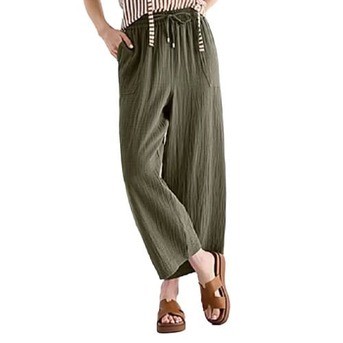 Woman wearing olive green, wide-leg pants with a drawstring waistband, paired with a striped top and brown platform sandals.