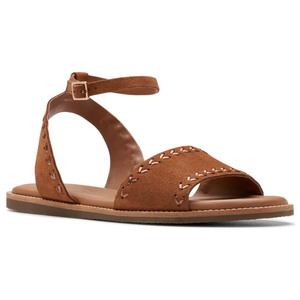 Brown suede sandals with a flat sole, featuring decorative stitching, an open toe, and an adjustable ankle strap with a buckle closure.
