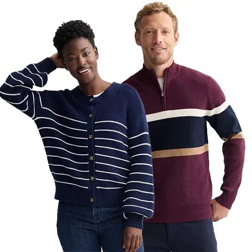 Two people are wearing sweaters: the woman in a navy blue cardigan with white stripes and the man in a burgundy quarter-zip sweater with navy, white, and tan stripes.