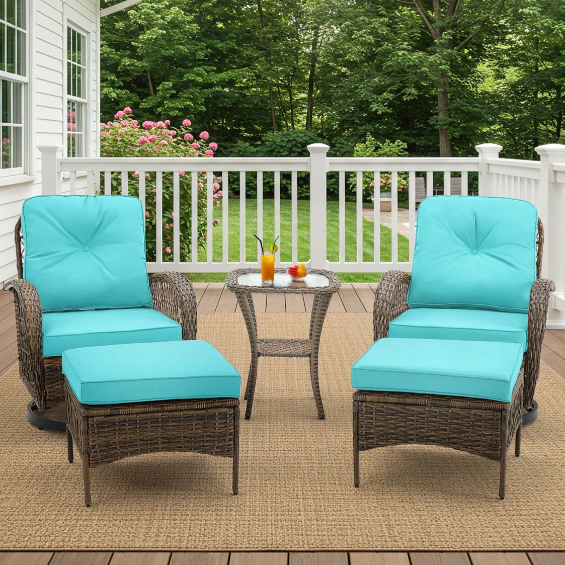 Outdoor patio set with two wicker chairs featuring turquoise cushions, matching ottomans, and a small wicker side table.
