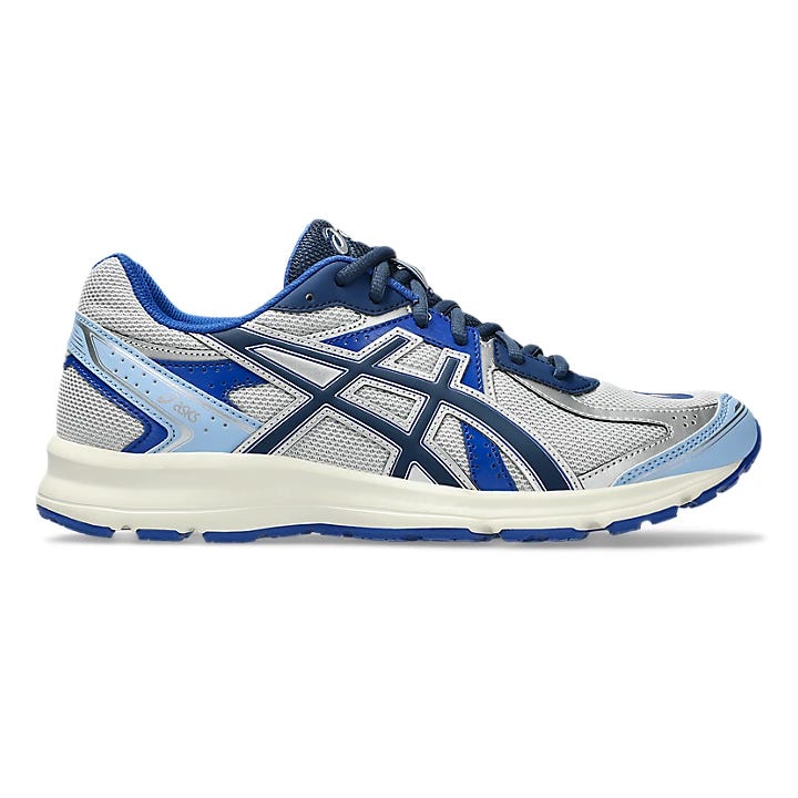 A blue and silver athletic shoe with black accents, featuring a prominent brand logo on the side and a cushioned white sole designed for running or sports use.