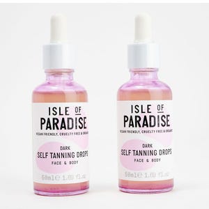 Two bottles of Isle of Paradise dark self-tanning drops for face and body, each with 50ml content, vegan friendly and cruelty-free.