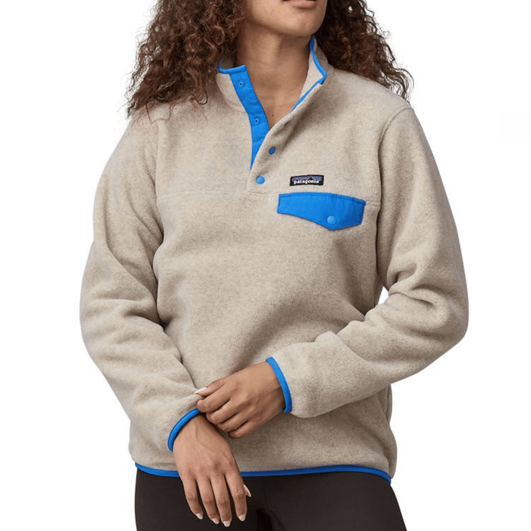Beige fleece pullover with blue accents, featuring a snap-button placket, blue chest pocket with button closure, and a logo on the chest.