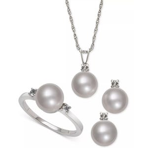 A jewelry set featuring a necklace, ring, and earrings with round pearls and small diamond accents, set in a silver or white gold finish.