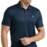 A man is wearing a dark patterned polo shirt with a penguin logo on the chest, paired with dark pants and a black belt.