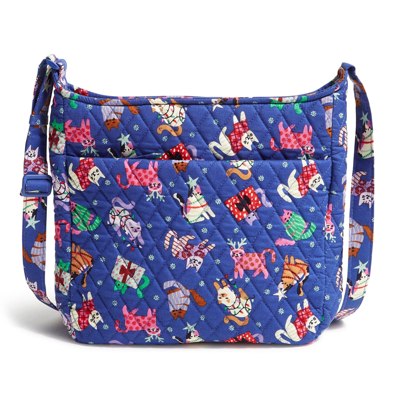 A quilted Vera Bradley XL Crossbody bag with a vibrant blue background featuring colorful cats in various playful poses wearing winter clothing. It has an adjustable strap and multiple exterior pockets.