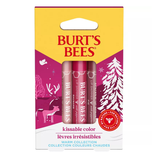 Burt's Bees Kissable Color gift set with three lip shimmers in warm shades, featuring peppermint. Packaging displays winter-themed graphics in pink and white.