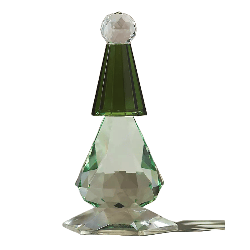 A faceted glass tree with a green conical top and a clear spherical finial, featuring a hexagonal base and a clear faceted body with green accents.