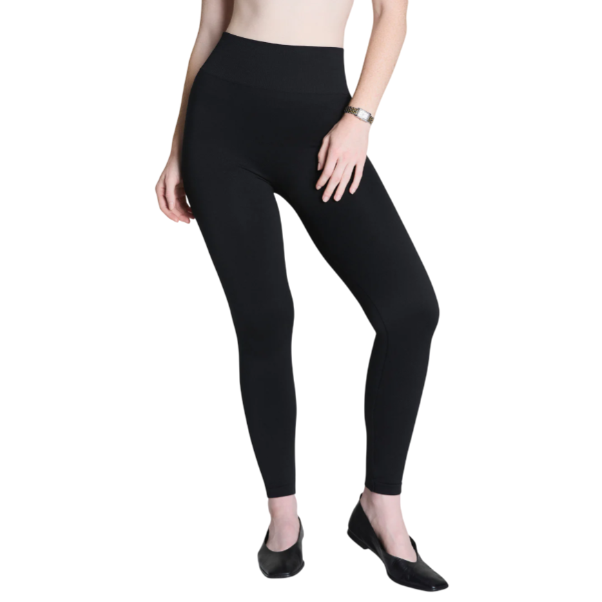 Black high-waisted leggings paired with black slip-on shoes.