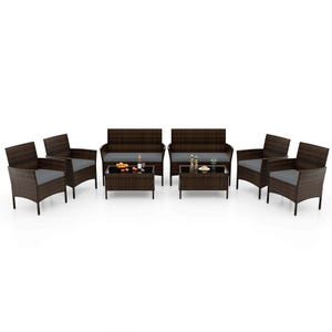 8-piece Costway patio set includes four armchairs, two loveseats, and two coffee tables, all in dark brown synthetic rattan with black glass table tops. Each seating piece has cushions for comfort.