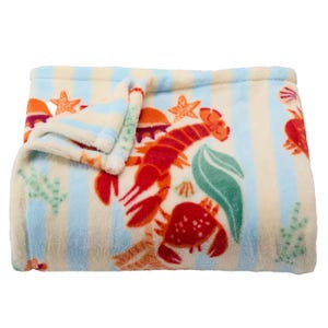 A soft fleece blanket with a colorful sea-themed design featuring lobsters, crabs, starfish, and coral on a light blue and white striped background.
