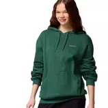 A person is wearing a green Columbia hoodie featuring a front pocket and drawstrings.
