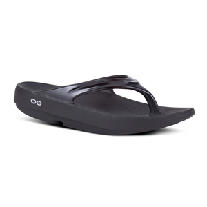 Black slip-on thong-style sandals with a contoured footbed and a slight platform heel, featuring a small circular logo on the side.
