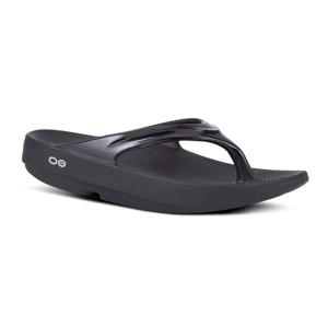 Black slip-on thong-style sandals with a contoured footbed and a slight platform heel, featuring a small circular logo on the side.