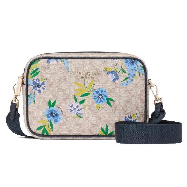 A Kate Spade crossbody bag featuring a beige floral pattern with blue and green accents, a navy strap, and gold-tone hardware.