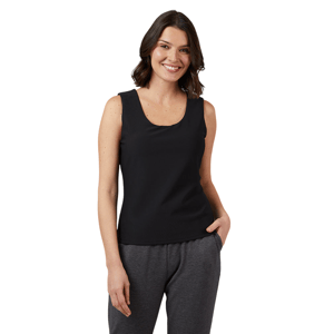 A woman is wearing a black sleeveless tank top paired with dark gray sweatpants, standing against a neutral gray background.