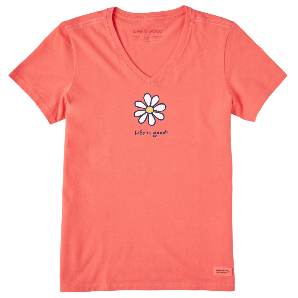 Coral-colored V-neck T-shirt featuring a white daisy with a yellow center and the text \“Life is good.\“ in navy blue.
