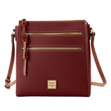 A burgundy crossbody bag with two front zippered pockets, a braided leather zipper pull, and an adjustable shoulder strap. The bag has a gold Dooney & Bourke logo plaque.