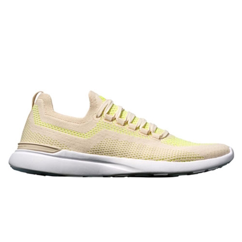 Light yellow APL Techloom Breeze sneakers with a low-top design, knit upper, and white sole.