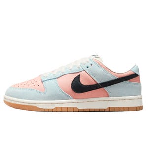 Nike Women's Dunk Low Shoes feature a combination of pastel pink and blue suede, with a black swoosh and a gum sole. The design offers a stylish and sporty look.