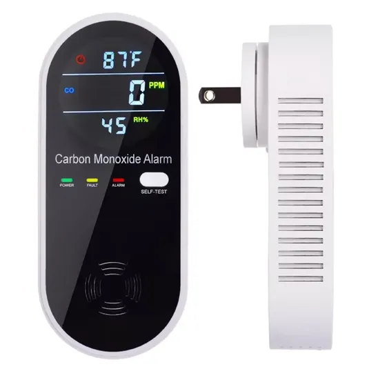 A digital carbon monoxide alarm with temperature and humidity display, featuring power, fault, and alarm indicators, as well as a self-test button. It's designed for wall plug-in installation.