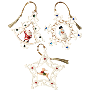 Three Christmas ornaments featuring a Santa, a snowman, and a reindeer inside intricate white designs with green, blue, and red accents, each with a gold tassel string.