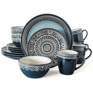 A set of blue and white patterned dinnerware including plates, bowls, and mugs.