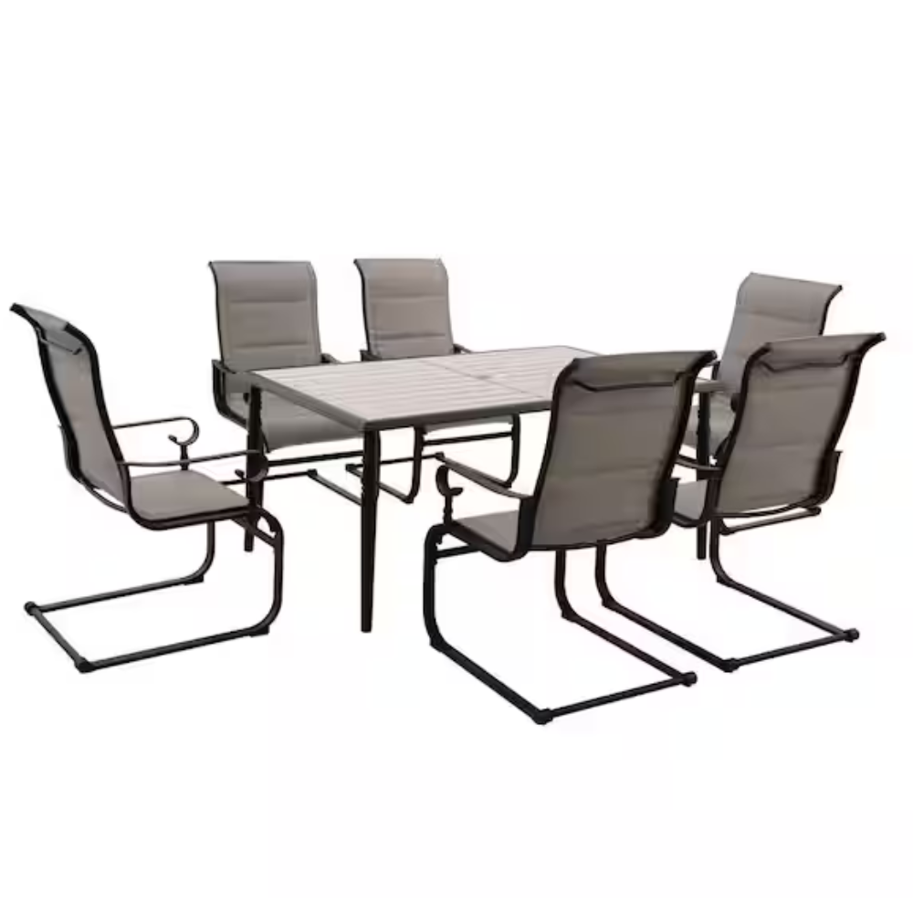 A patio dining set with six gray cushioned chairs and a rectangular table featuring a slatted top and dark metal frame.