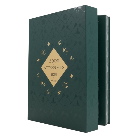 Aldo X Wicked 12 Days of Accessories Box features a dark green design with golden crescent moons and stars. The box promises a collection of accessories themed around \“Wicked,\“ associated with Aldo.