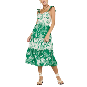 Green and white floral print sundress with tie straps and a tiered skirt, paired with strappy wrap-around sandals.