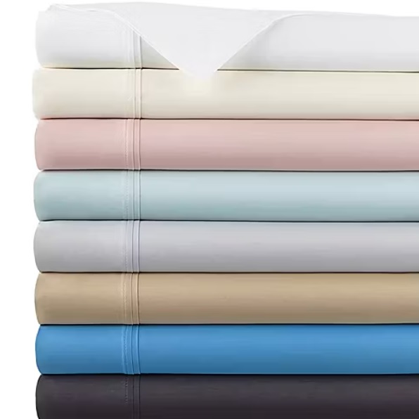 A stack of neatly folded bed sheets in various colors including white, cream, pink, light blue, gray, beige, blue, and dark gray.