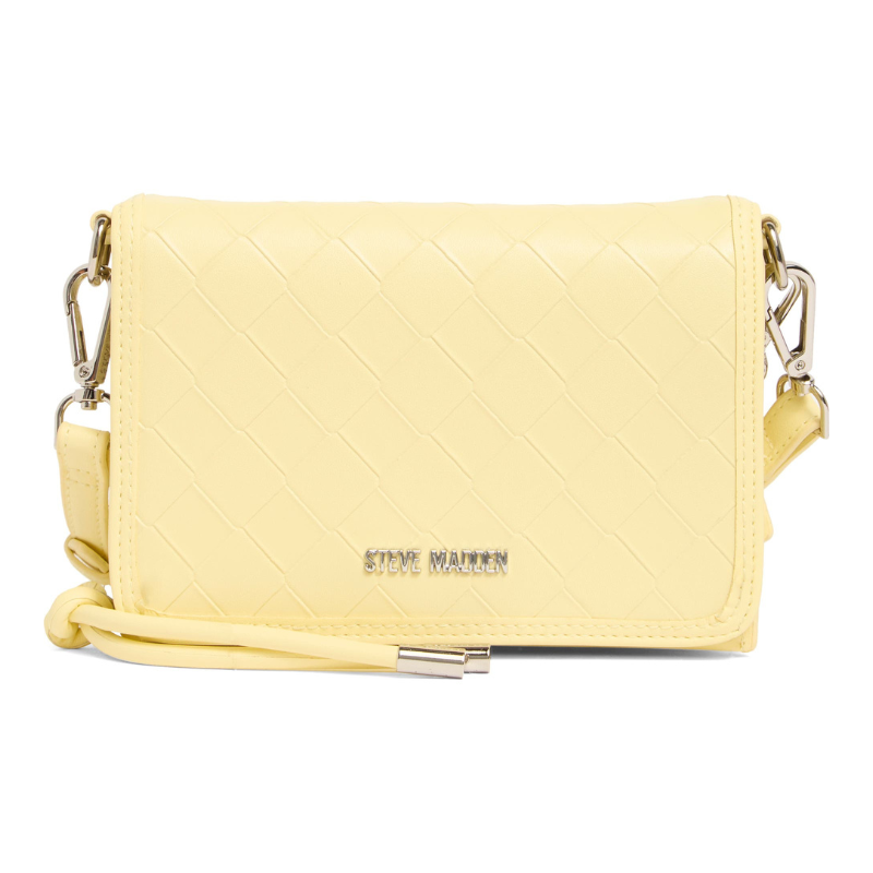 Steve Madden Siena Embossed Crossbody Bag in pale yellow features a quilted pattern, detachable straps with clips, and metallic branding on the front.