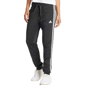Black Adidas track pants with white stripes and logo, paired with white sneakers.
