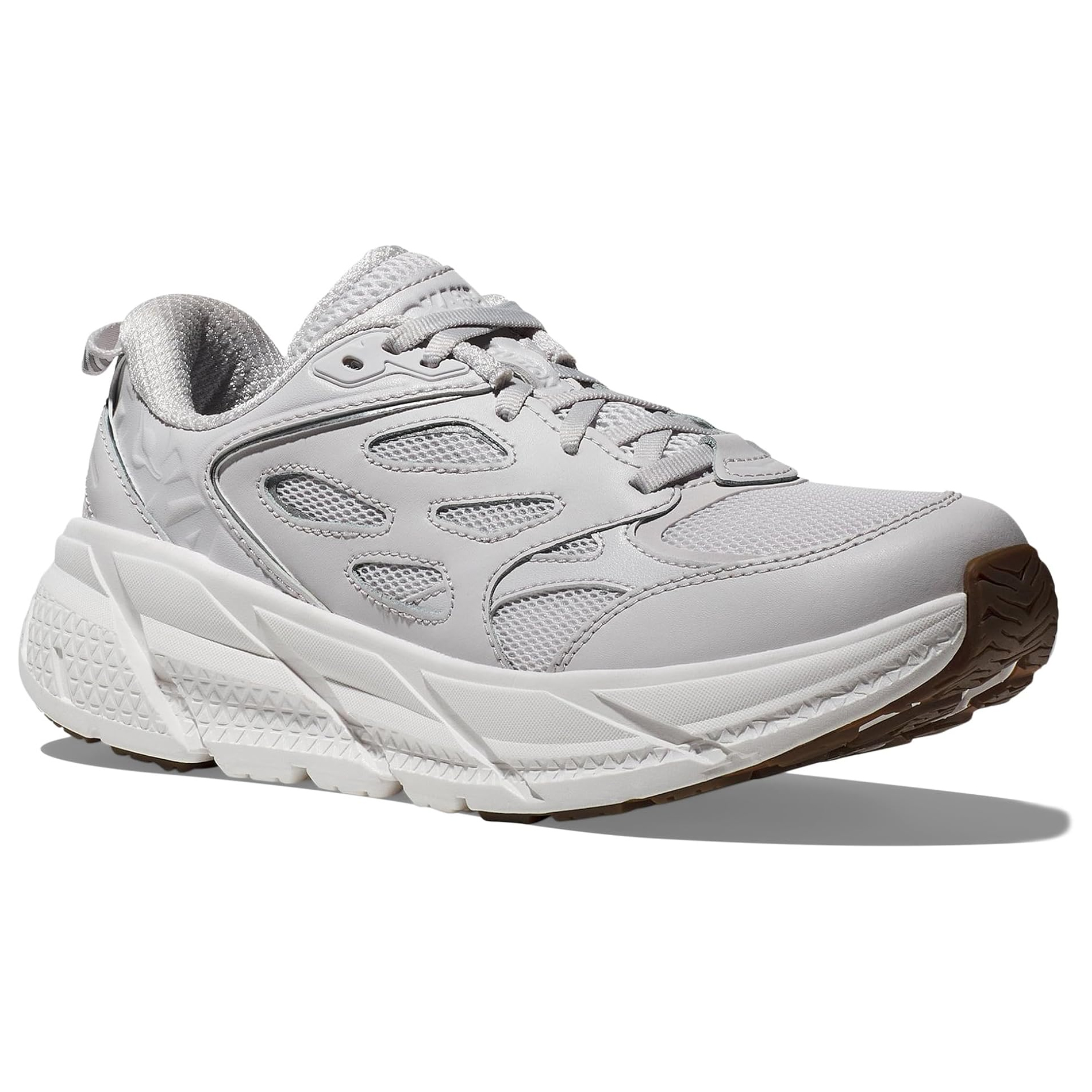 Hoka Clifton Athletic Shoes feature a chunky, textured sole for cushioning, a mesh and synthetic upper in white and grey for breathability, and a sturdy lace-up design.