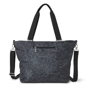 A dark gray tote bag with a floral pattern, featuring two straps and a detachable shoulder strap. It has a zippered front pocket and metal hardware.