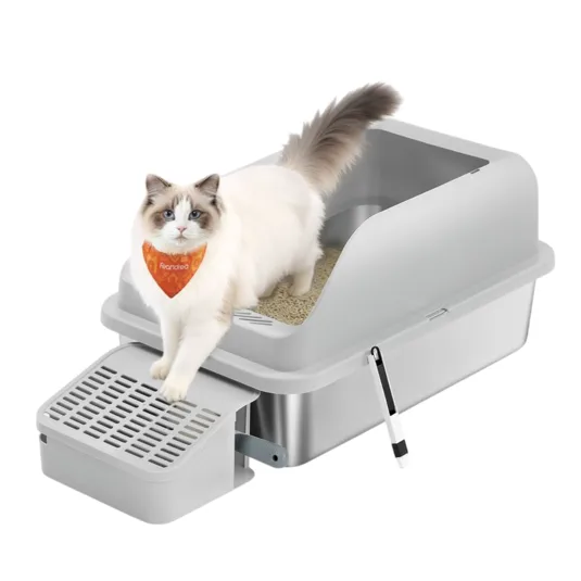 A white and gray cat wearing an orange bandana is exiting a gray self-cleaning litter box with a built-in sifting system.