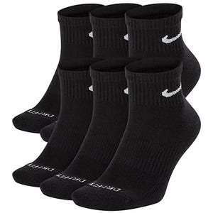 A six-pack of black ankle socks with a white swoosh logo and \“DRY FIT\“ text on the toe area.