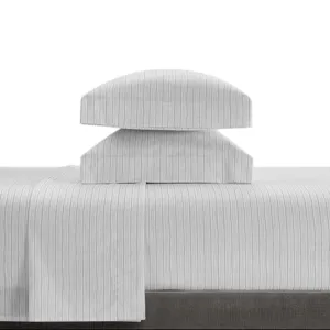 A stack of two pillows covered in white fabric with subtle vertical pinstripes, placed on a matching pinstriped bedsheet.