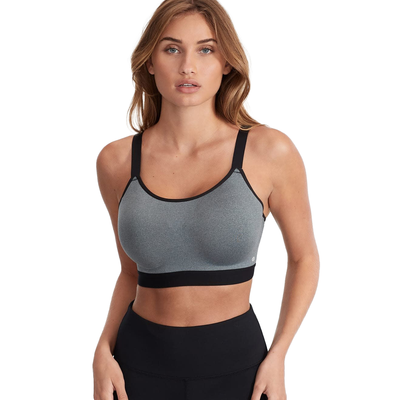A woman wearing a gray sports bra with black straps and a black band, paired with black leggings.