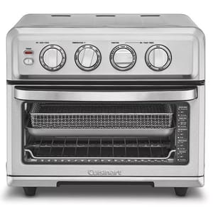 A countertop toaster oven and air fryer with control knobs for timer, temperature, and function features a front door and a slide-out tray.