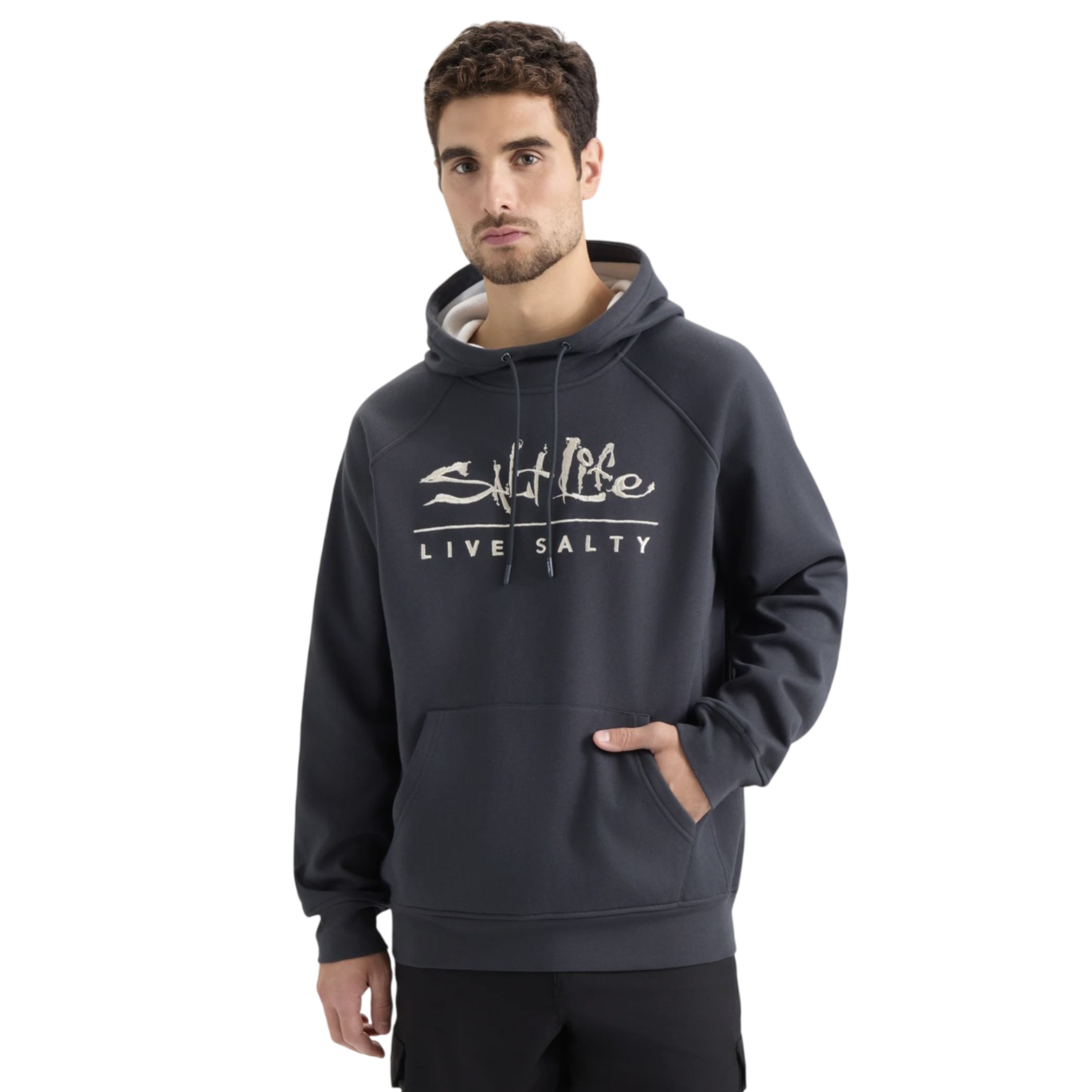 A man is wearing a dark grey hoodie with the text \“Salt Life Live Salty\“ printed on the front. The hoodie features a drawstring hood and a front pocket.