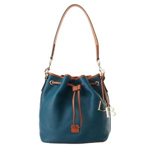 A Dooney & Bourke drawstring bucket bag in teal features tan leather accents, a drawstring closure, and a shoulder strap with metal hardware. It includes a small leather tag and a decorative metal charm for branding.
