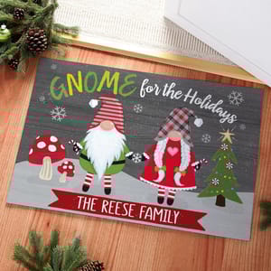 Festive holiday doormat featuring gnome designs, snowflakes, mushrooms, and a decorated tree with the phrase \“GNOME for the Holidays\“ and personalized with \“The Reese Family.\“